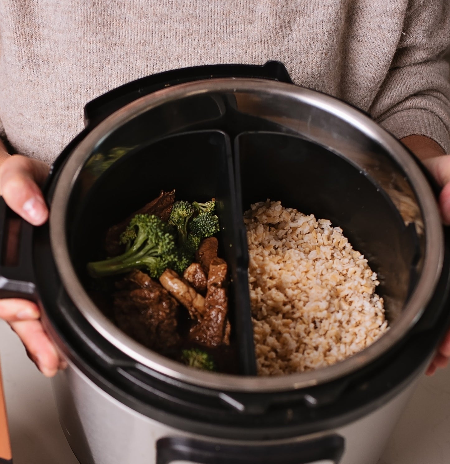 image with beef and chicken in one pressure cooker pocket and rice in another pocket